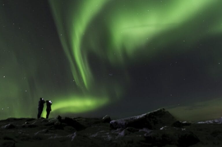Northern Lights Iceland | Iceland Travel Guide, two people watching the northern lights in Iceland