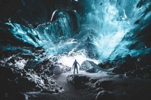 Ice Cave Tours, a man standing inside Katla Ice Cavel the best summer self driving tours in Iceland