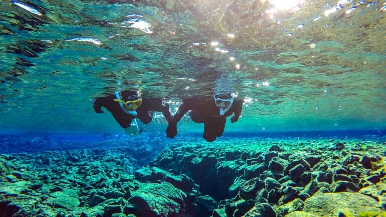 two people on a Snorkel Silfra tour in Thingvellir National Park