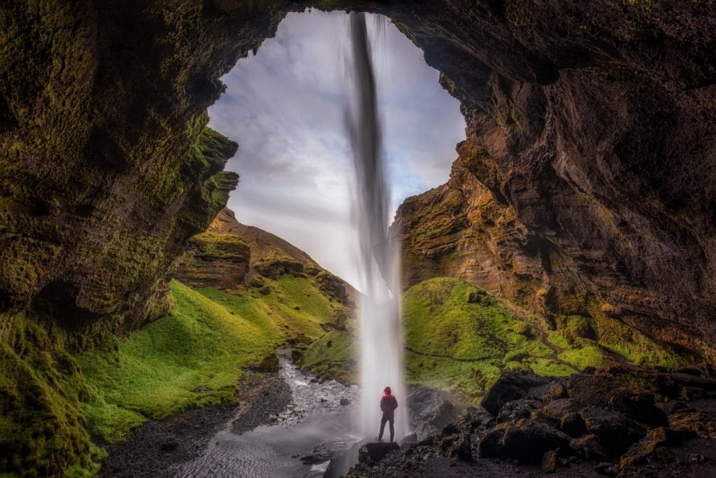 Kvernufoss waterfall during summer in Iceland, walk behind waterfall in south Iceland, hidden waterfall in south Iceland