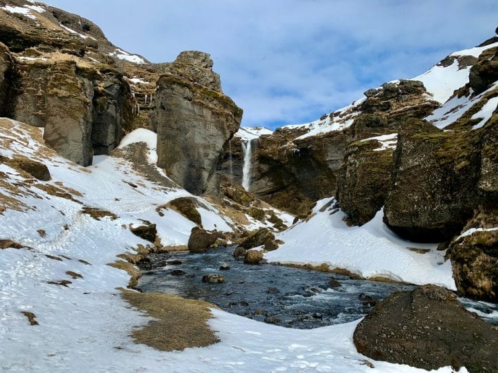 Kvernufoss waterfall during winter in Iceland, walk behind waterfall in south Iceland