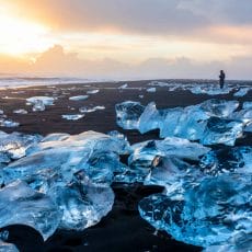 man standing and watching the sunset at Diamond Beach in south Iceland