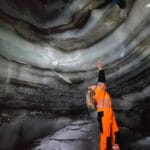 woman standing inside Langjokull natural ice cave