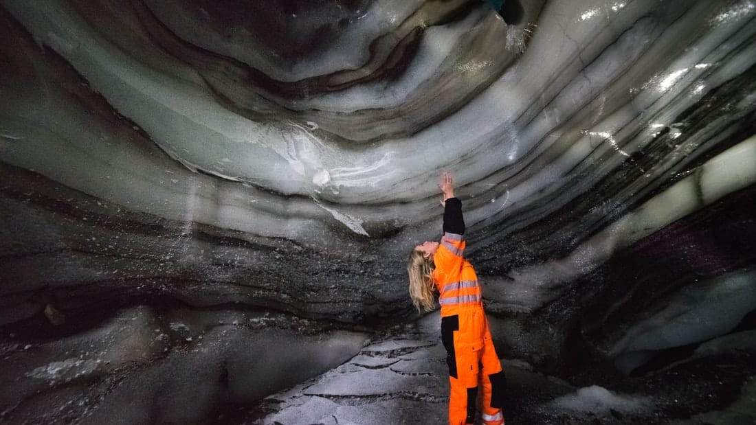 woman standing inside Langjokull natural ice cave