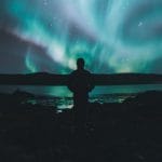 man watching the northern lights in Iceland