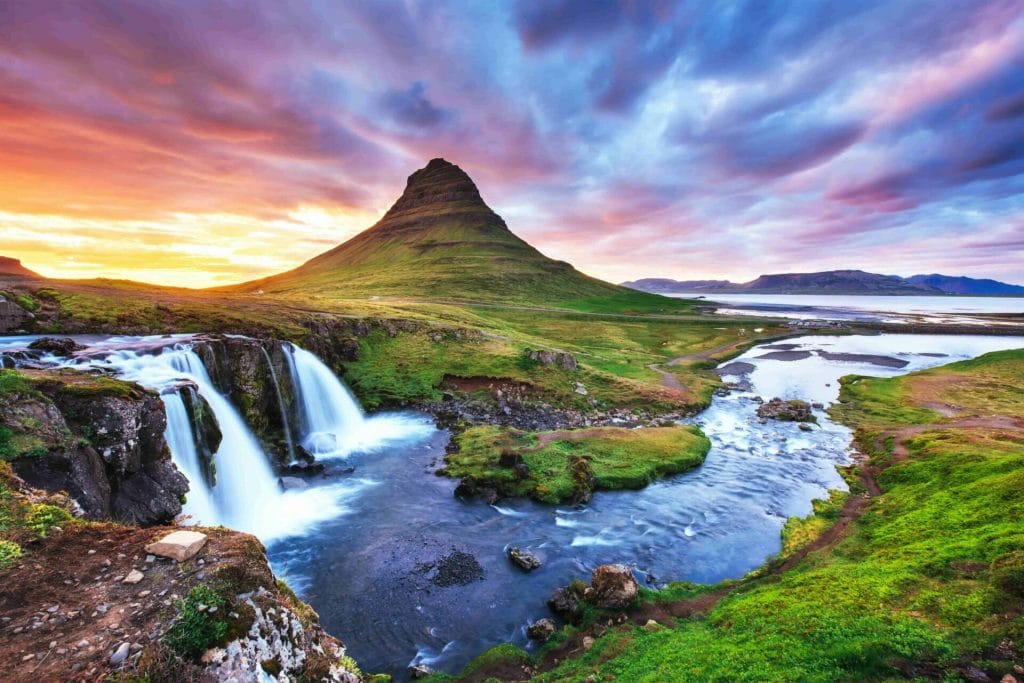 Kirkjufell mountain and Kirkjufellsfoss waterfall at sunset in Snæfellsnes Peninsula