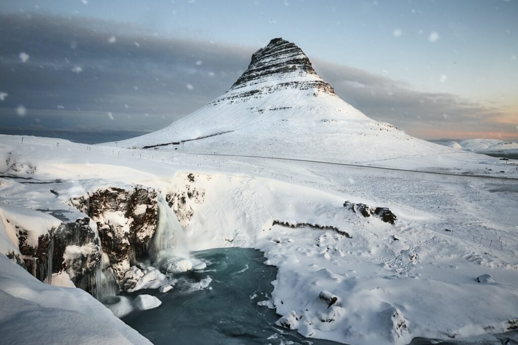 Kirkjufell mountain and Kirkjufell waterfall in Snæfellsnes during winter with snow