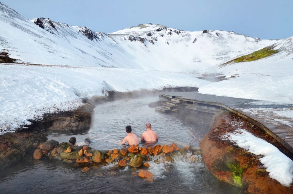 Iceland Hot Springs, hot springs in Iceland, two men sitting in Reykjadalur hot spring on the Reykjadalur hot spring and hike