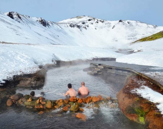 Iceland Hot Springs, hot springs in Iceland, two men sitting in Reykjadalur hot spring on the Reykjadalur hot spring and hike