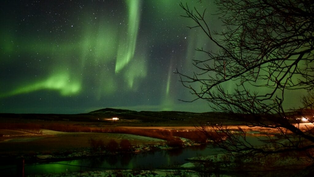 northern lights above Krauma natural baths in west Iceland