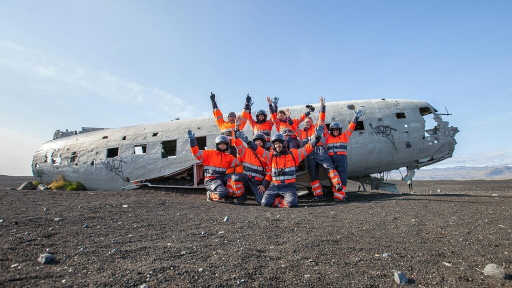 atv in Iceland, atv Iceland, group of people in front of Sólheimasandur Plane Wreck in south Iceland on a ATV tour