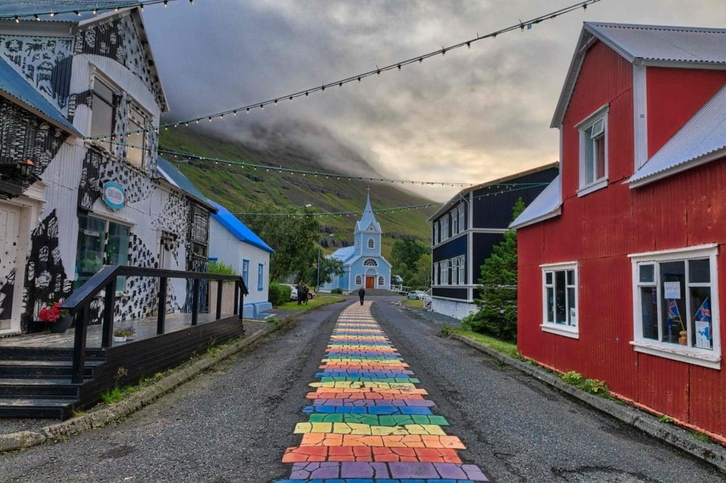 Seyðisfjörður, rainbow street and blue church in Seyðisfjordur village in east Iceland