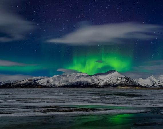 northern lights dancing above a mountain in Iceland