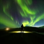 Northern Lights Iceland | Iceland Travel Guide, man watching the northern lights in Iceland