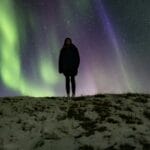 man watching the northern lights in Iceland