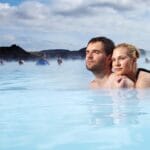 A couple bathing in the Blue Lagoon in Iceland