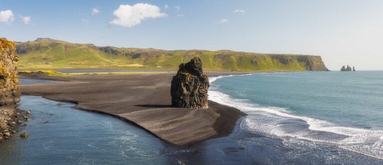 Kirkjufjara black sand beach and Eagle Rock in south Iceland