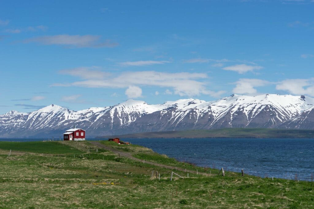 red house standing alone in the summer in Dalvík village in north Iceland