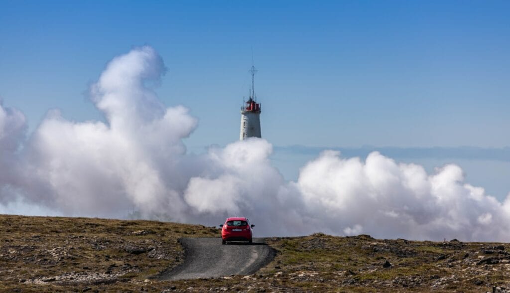 car driving in front of Gunnuhver hot spring in Reykjanes Peninsula Iceland