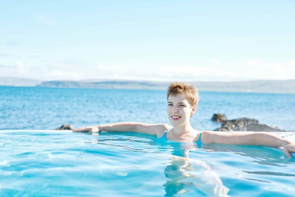 woman in swimming pool with a view in Iceland