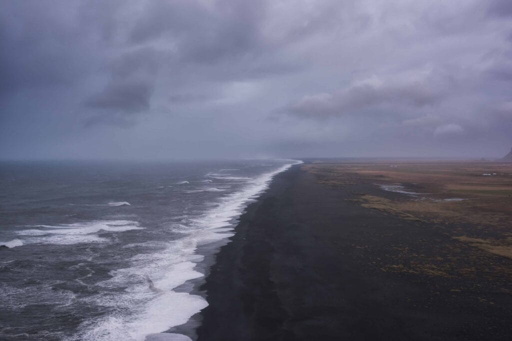 view over the black sand beach and ocean from Dyrhólaey cliffs in south Iceland