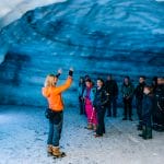a group of people visiting into the glacier ice cave in Langjokull