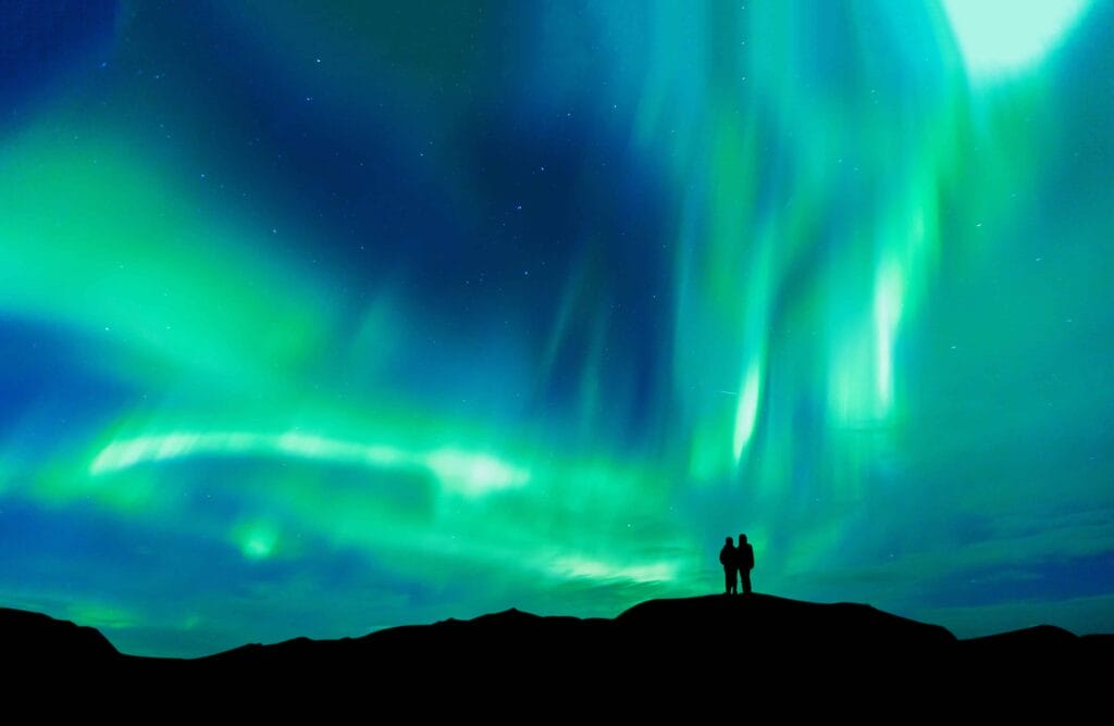 Northern Lights Iceland | Iceland Travel Guide, Honeymoon in Iceland, two people watching the northern lights in Iceland