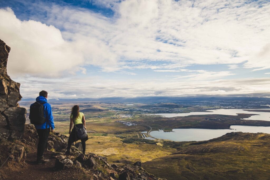 Honeymoon in Iceland, hiking on Esjan mountain with view over Reykjavik