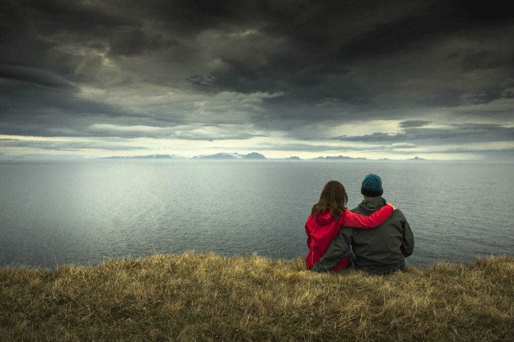 Honeymoon in Iceland, two people sitting with a view in Iceland