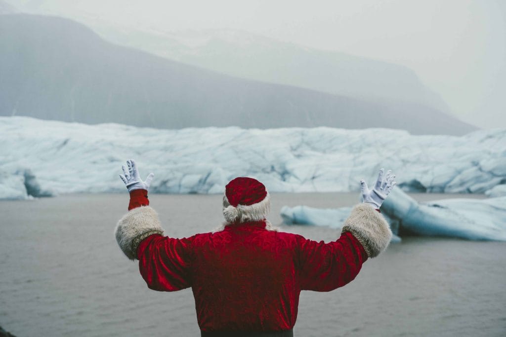 Christmas in Iceland - Yule lads in Iceland - santa claus standing in front of the glacier lagoon