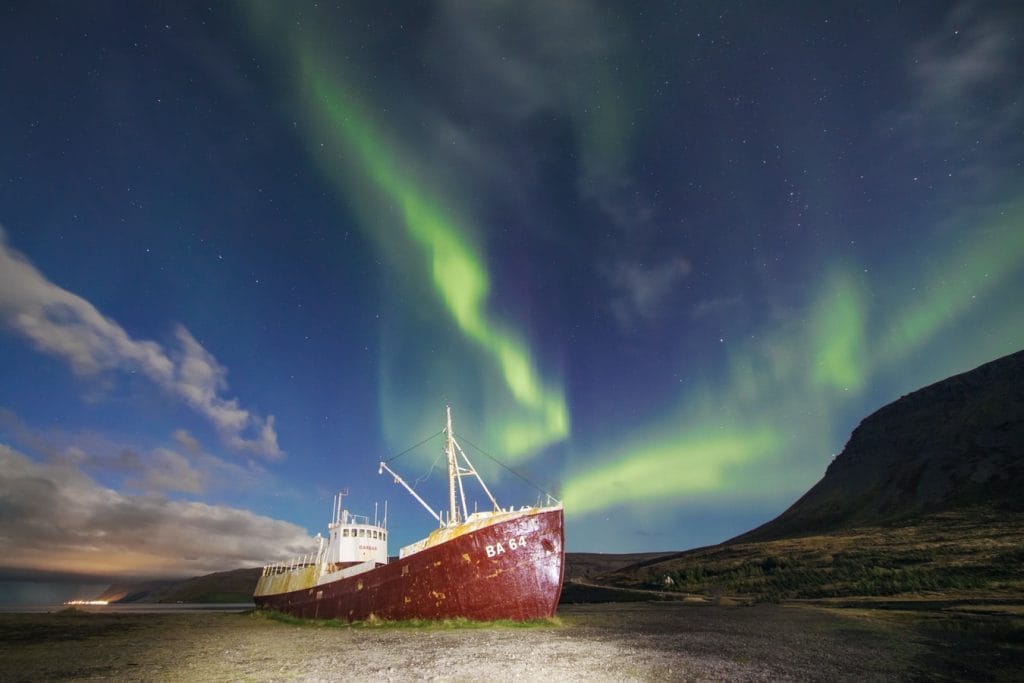northern lights over Garðar BA 64 Ship wreck in Westfjords