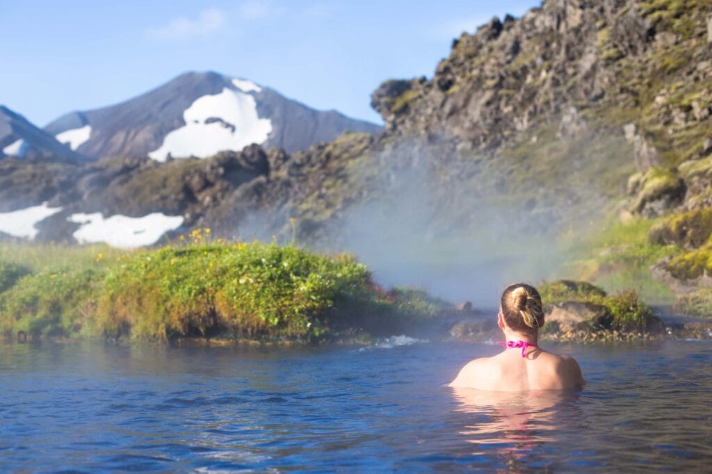 Iceland hot spring, woman bathing in Landmannalaugar hot spring in the highlands of Iceland