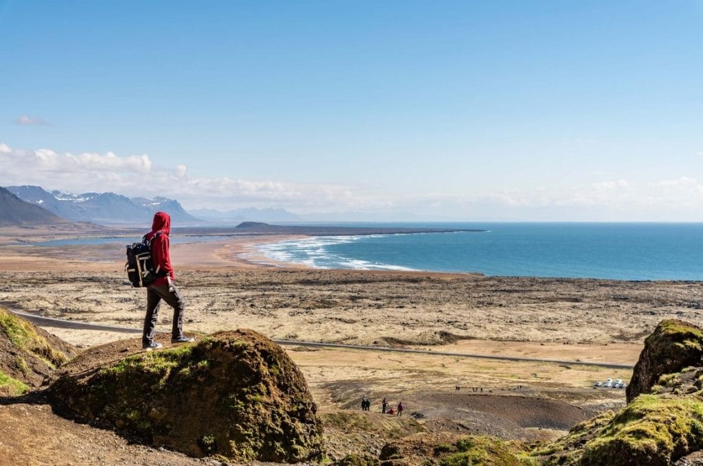 man standing with a view over Snæfellsnes Peninsula from Rauðfeldsgjá Gorge in Snæfellsnes Peninsula