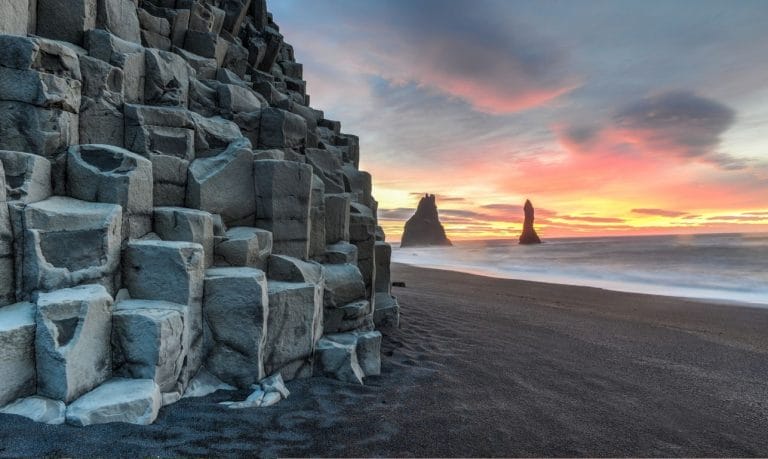 Reynisfjara black sand beach and Reynisdrangar basalt columns at sunset