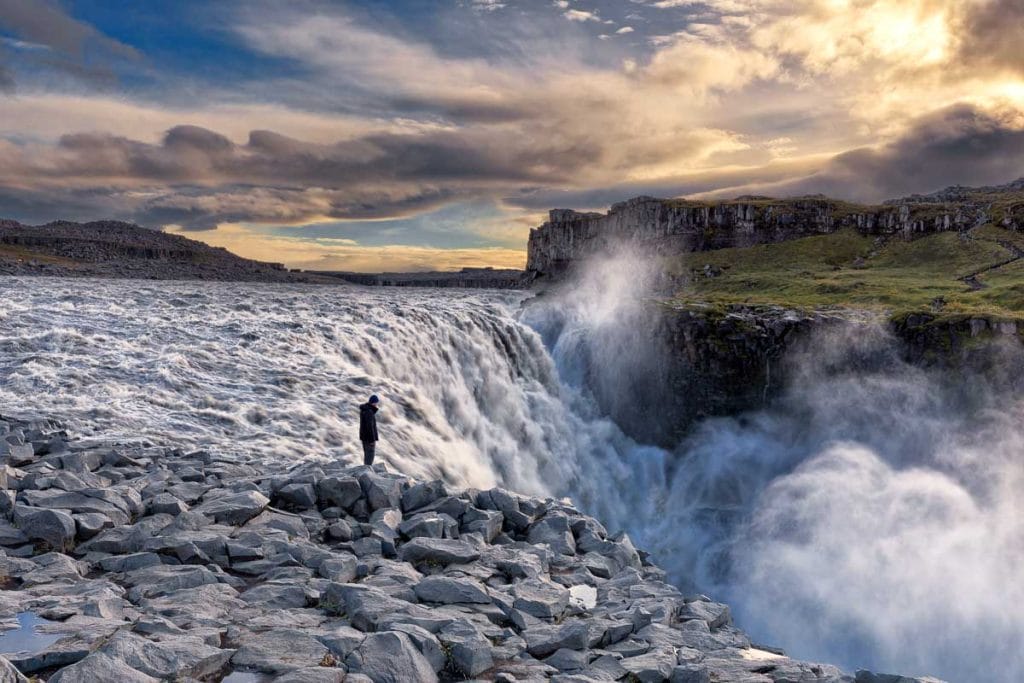 A powerful view of Dettifoss waterfall, the largest in Europe, located in North Iceland along the Diamond Circle route. The glacial waters cascade 45 meters into the rugged canyon below, surrounded by volcanic landscapes.