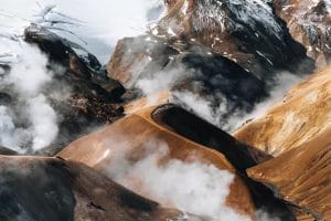Hiker traversing the vibrant rhyolite hills of Kerlingarfjöll
