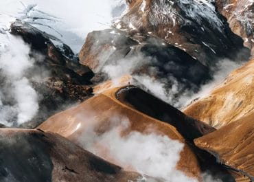 Hiker traversing the vibrant rhyolite hills of Kerlingarfjöll