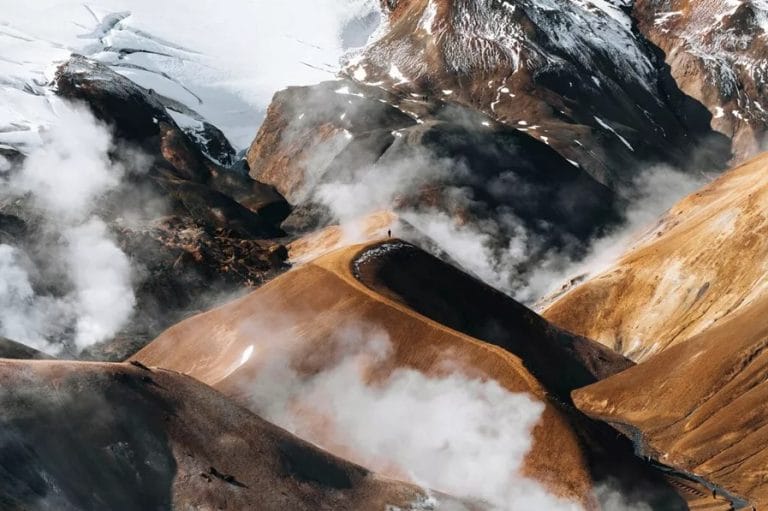 Hiker traversing the vibrant rhyolite hills of Kerlingarfjöll