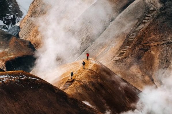 Hiker traversing the vibrant rhyolite hills of Kerlingarfjöll