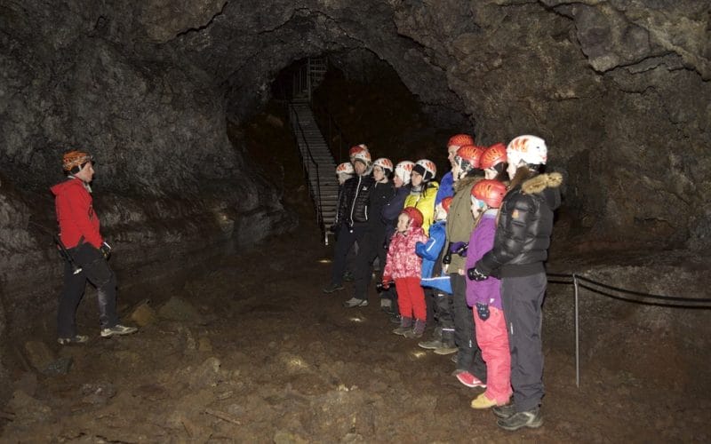 people on a tour in Vatnshellir lava cave in Snæellsnes Peninsula