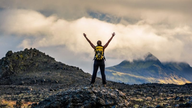 Man on top after hiking Þrihyrningur mountain in south Iceland