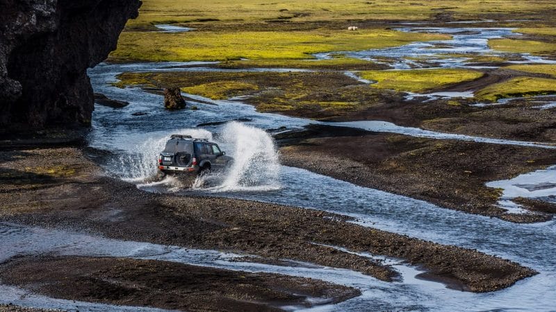 Super jeep driving over a river on a Highland Super Jeep Excursion in south Iceland
