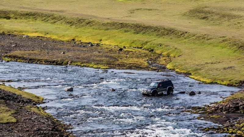 Super jeep driving over a river on a Highland Super Jeep Excursion in south Iceland