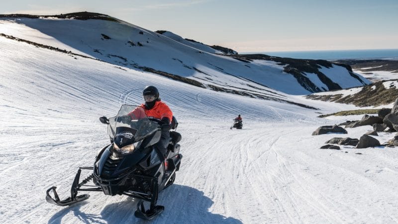 Iceland Snowmobile Tour, Snowmobile Iceland, Snowmobiling in Iceland, people riding a snowmobile on Eyjafjallajokull snowmobile tour in south Iceland