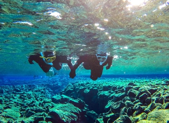 two people on a Snorkel Silfra tour in Thingvellir National Park
