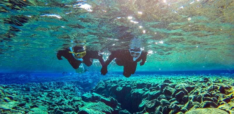 two people on a Snorkel Silfra tour in Thingvellir National Park
