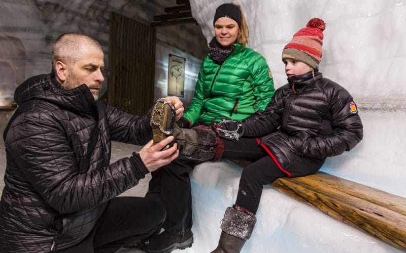 a group of people visiting into the glacier ice cave in Langjokull