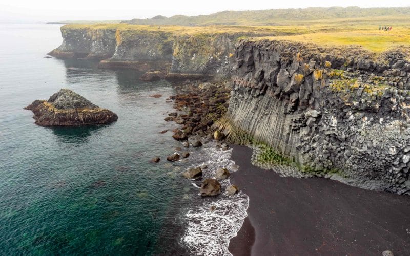 black sand beach and lava cave at Arnarstapi fishing village in snæfellsnes peninsula