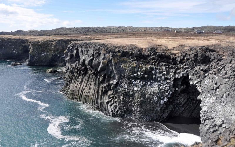black sand beach and lava cave at Arnarstapi fishing village in snæfellsnes peninsula