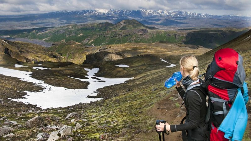 Hiking with a backpack and water bottle in Iceland
